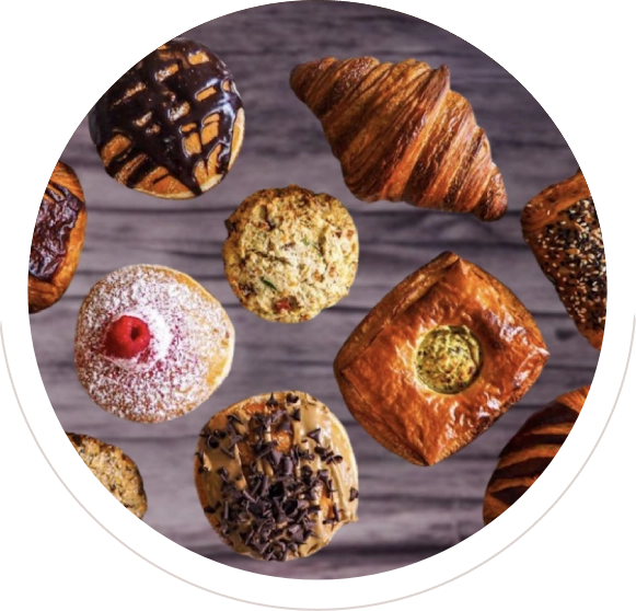 Assorted freshly baked pastries and cookies on a wooden surface.